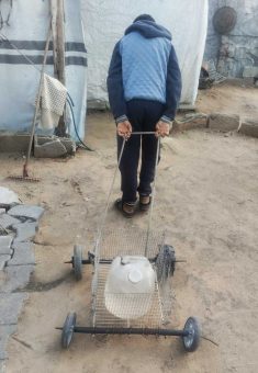 Nabilah ‘Abd a-Nabi’s family member, wheeling a water jug for the family. Photo courtesy of ‘Abd a-Nabi