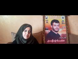 Nisrin Jaber with a photo of her brother Muhammad; she hasn’t seen him since 2016. Photo by Olfat al-Kurd, B’Tselem, 2 May 2019