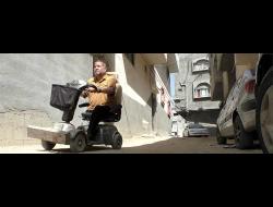 ‘Abd a-Rahman al-‘Ar’ir on the scooter he depends on to get around. When the power is out, he can’t charge it or leave home. Photo by Muhammad Sabah, B'Tselem.