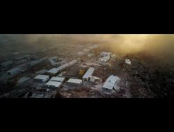 Smoke from tires burned by Palestinian protesters looms over the Evyatar outpost. Photo by Amir Cohen, Reuters, 23 June 2021