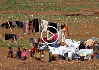 Family by remains of their possessions after most recent demolition. Taken from video footage