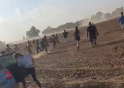 Israeli civilians fleeing armed Palestinians near Re'im, an Israeli community near the Gaza border. Still photo from a video posted on social media. Photo used under Sec. 27a of the&nbsp;Copyright&nbsp;Law