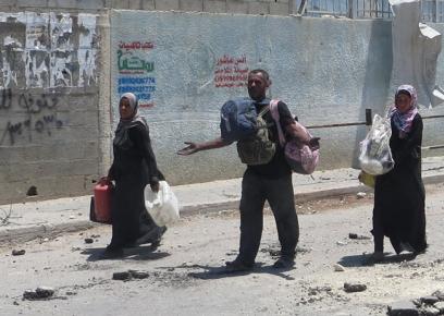 תושבים עוזבים את בית חאנון במהלך הפוגה הומניטארית.  צילום: מוחמד סבאח, בצלם, 26.7.14