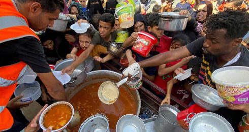 Food being distributed in an UNRWA school in Rafah where Gaza residents are sheltering. Photo: Mahmoud al-Masri via Reuters  