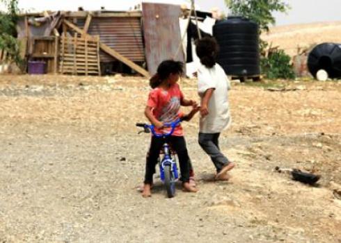 Children playing in Khan al-Ahmar. Photo: Rima Essa, B'Tselem