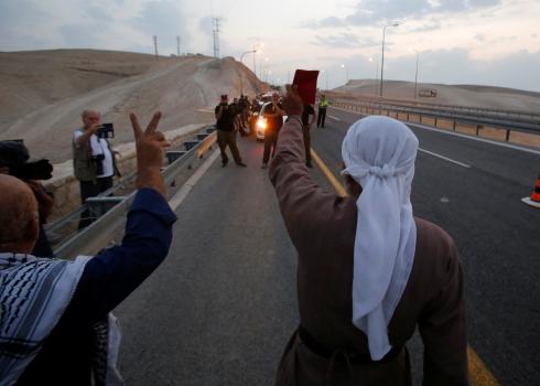 Activists face security forces in protest after the confiscation. Photo by Mussa Qawasma, Reuters, 13 Sept. 2018