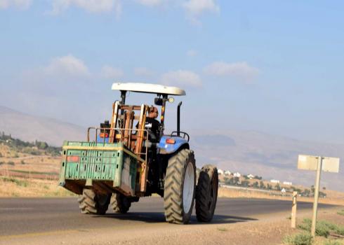 A Civil Administration employee driving the confiscated tractor. Photo: ‘Aref Dagharmeh, B'Tselem, 6 August 2019