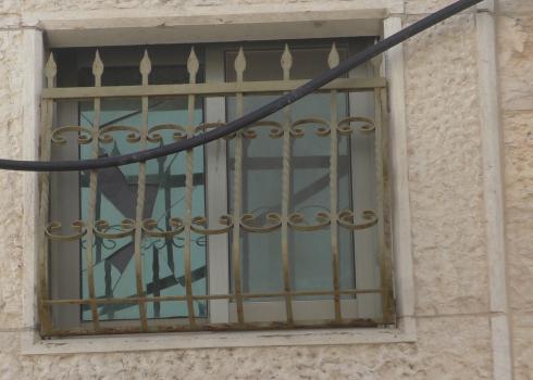 A shattered window in the Idris family home, Khallet a-Natash, 16 Jan. 2021. Photo by Rajaai Tarif