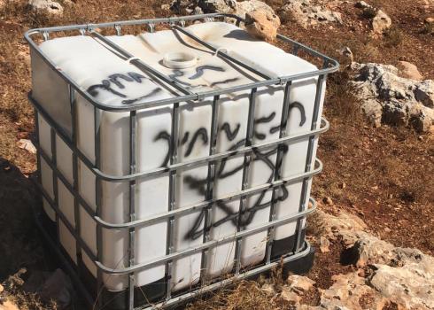The slogan graffitied by the settlers on the water container. Photo courtesy of landowner.