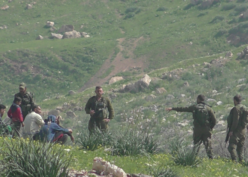 Soldiers detaining residents of Khallet Makhul. Photo courtesy of the residents