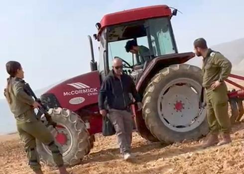 Settler sitting in Ayman Bani ‘Odeh’s tractor. Photo courtesy of the witness. 