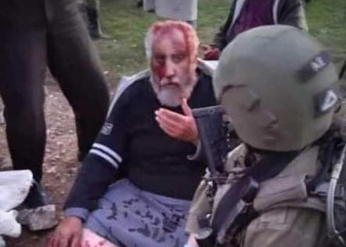 A soldier extending first aid to Muhammad Shalaldeh after the attack. Photo courtesy of the family