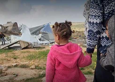 Residents of She'b al-Batem watch one of the structures being demolished. Photo: Nasser Nawaj'ah, B'Tselem, 6 March 2023 