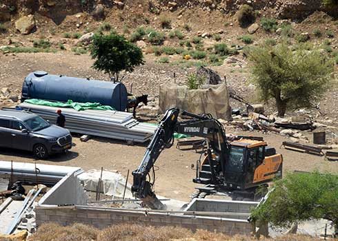 A bulldozer demolishing one of the houses in Khirbet al-Maleh. Photo: ‘Aref Daraghmeh, B'Tselem 26 June 2023 