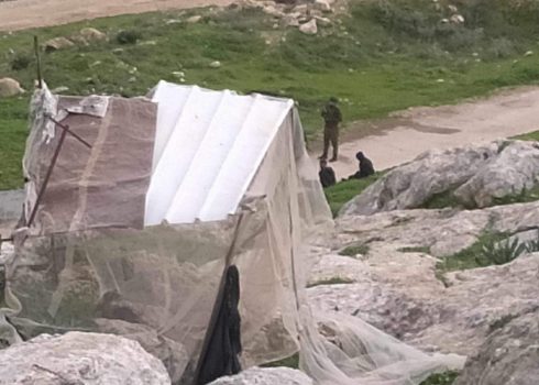 A soldier detaining Muhammad and Bilal Abu ‘Eid in ‘Ein Samia, on 10 February 2024. Photo courtesy of the family 