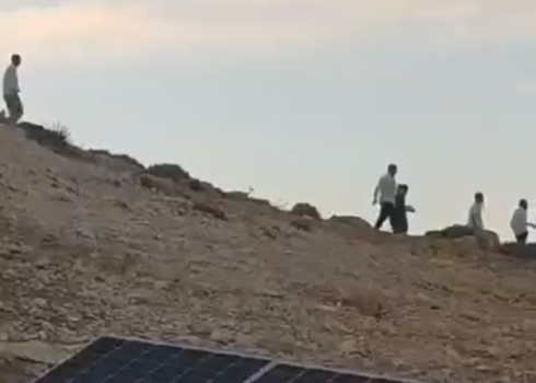 Settlers on Sawakrah's land a day before he and his flock were attacked. Still from video by community resident  