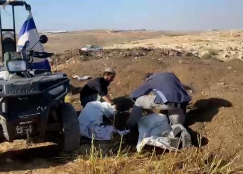 Settlers filling manure sacks. Photo courtesy of local residents