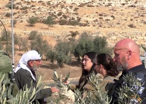  Israeli armed forces forbidding one of the farmers from harvesting on his land Photo courtesy of activists