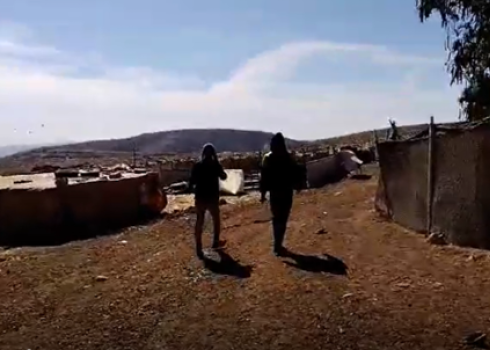 The two settlers walking around the residents’ homes on 18 December 2024. Photo courtesy of the residents.