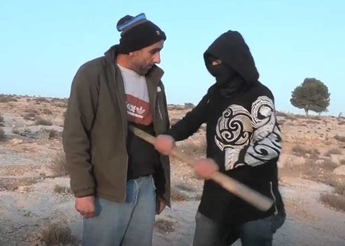 The settler hitting Nawaj’ah in the abdomen with a club. Photo courtesy of local residents
