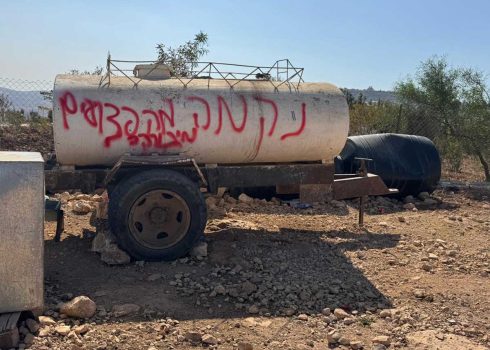 The graffiti sprayed by settlers on the water tanker. Photo: Mohammad Romaneh, B’Tselem