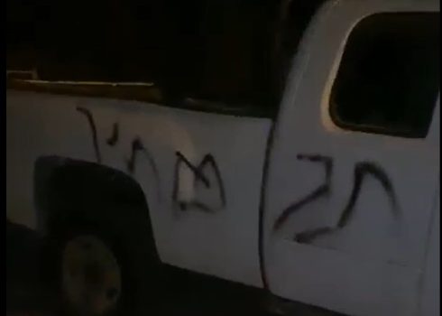 “Price tag” graffiti sprayed by settlers on one of the cars. Photo courtesy of local residents