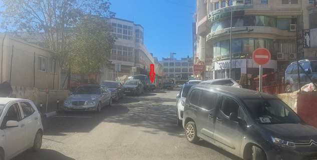 On the right: The City Center building. The arrow marks the spot where Qatawi was hit. Photo: Iyad Hadad, B’Tselem 