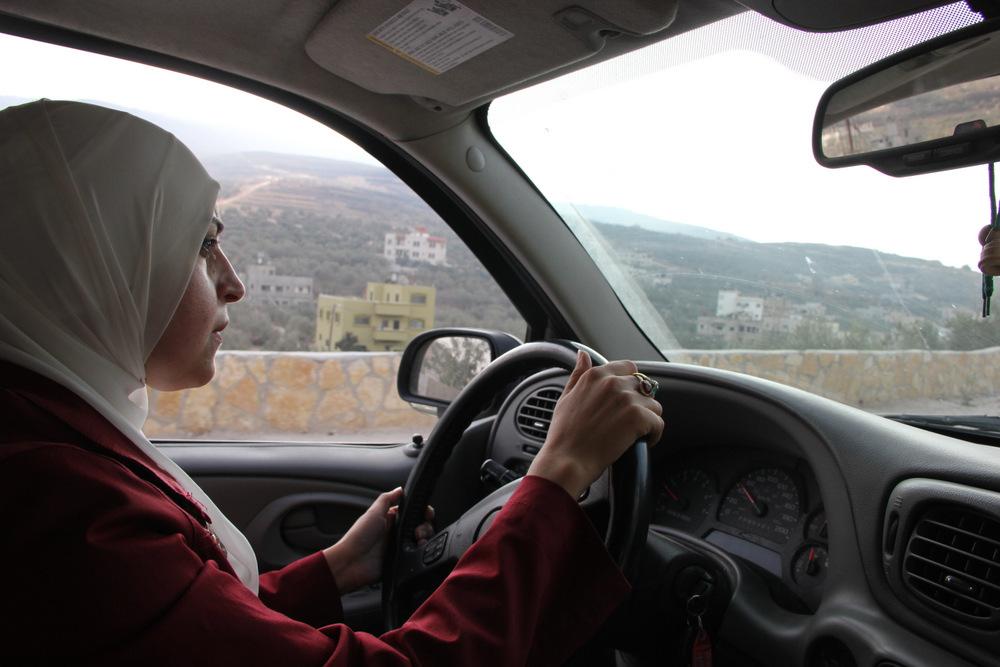 Salma a-Deb’i, B’Tselem field researcher for Nablus area, driving us to the village.