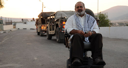 Sami Subuh, head of al-‘Aqabah Council during military training in the village, June 2012. Subuh, injured at 16 by gunfire during a military exercise, has been wheelchair-bound ever since. Photo by ‘Atef Abu a-Rub, B’Tselem, 27 June 2012. Sami Subuh, head of al-‘Aqabah Council during military training in the village, June 2012. Subuh, injured at 16 by gunfire during a military exercise, has been wheelchair-bound ever since. Photo by ‘Atef Abu a-Rub, B’Tselem, 27 June 2012.