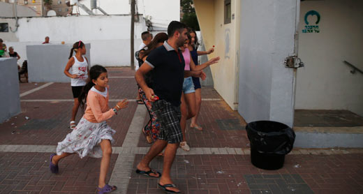 Ashkelon residents run for shelter during a siren. Photo: Baz Ratner, Reuters, 9 July 2014