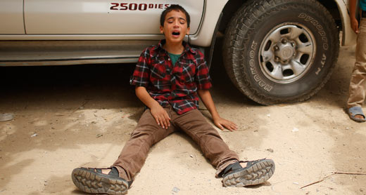 A child from al-Batsh family during the funeral. Photo: Muhammad Salem, Reuters, 13 July 14