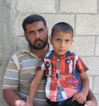 Tawfiq Abu Jame' and his son Nur a-Din. Photo: Khaled  al-‘Azayzeh, 16 Sept. 2014