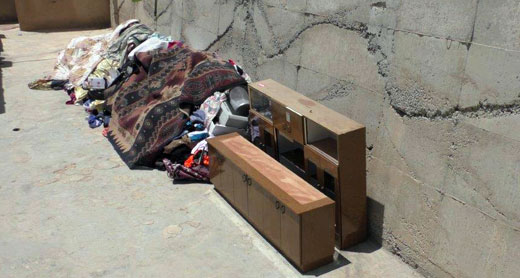 The family's belongings left in the street. Photo: 'Amer 'Aruri, B'Tselem, 1 July 2015