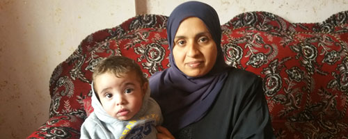 ‘Awatef Abu Daher and her son Na’im who requires urgent medical care in Israel. Photo by Khaled al-‘Azayzeh, B’Tselem, 7 Jan. 2016 ‘Awatef Abu Daher and her son Na’im who requires urgent medical care in Israel. Photo by Khaled al-‘Azayzeh, B’Tselem, 7 Jan. 2016