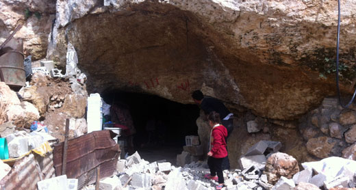 Residents of Khirbet Tana near entrance to residential cave demolished by the authorities. Photo by Abdulkarim Sadi, B’Tselem, 2 Mar. 2016