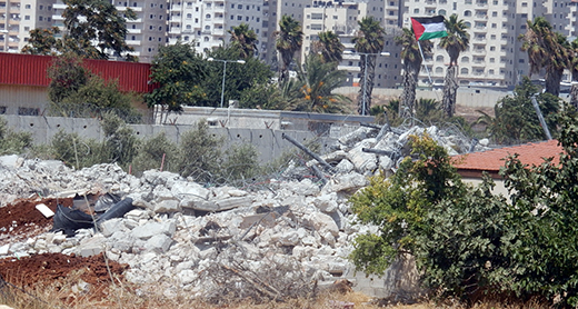 Ruins of the family home of Hisham Hussein with the Separation Barrier in the background. Photo by Iyad Hadad, B’Tselem 27 July 2016. Ruins of the family home of Hisham Hussein with the Separation Barrier in the background. Photo by Iyad Hadad, B’Tselem 27 July 2016.