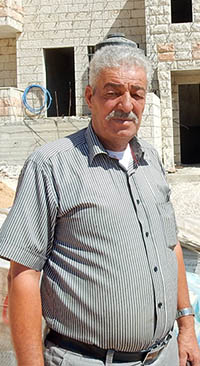 Raafat ‘Awaddalh in front of his building. Photo by Iyad Hadad, B’Tselem 27 July 2016.