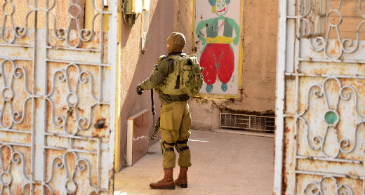  A soldier at the entrance to the home of the Abu Munshar family, Hebron. Photo by Anwar Abu Munshar, 24 Nov. 2016