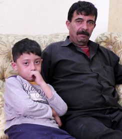 Muhammad a-Salaimeh at home with one of his children. Photo by Manal al-Ja’bri, B’Tselem, 18 June 2017